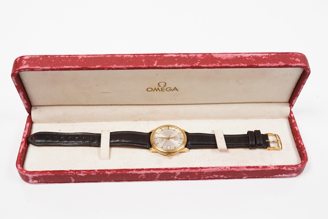 A gentleman's late 1990's 18ct gold Omega Automatic Chronometer wrist watch, with baton numerals and date aperture, case diameter 35mm, on an associated leather stray with plated buckle with Omega insignia, with box and